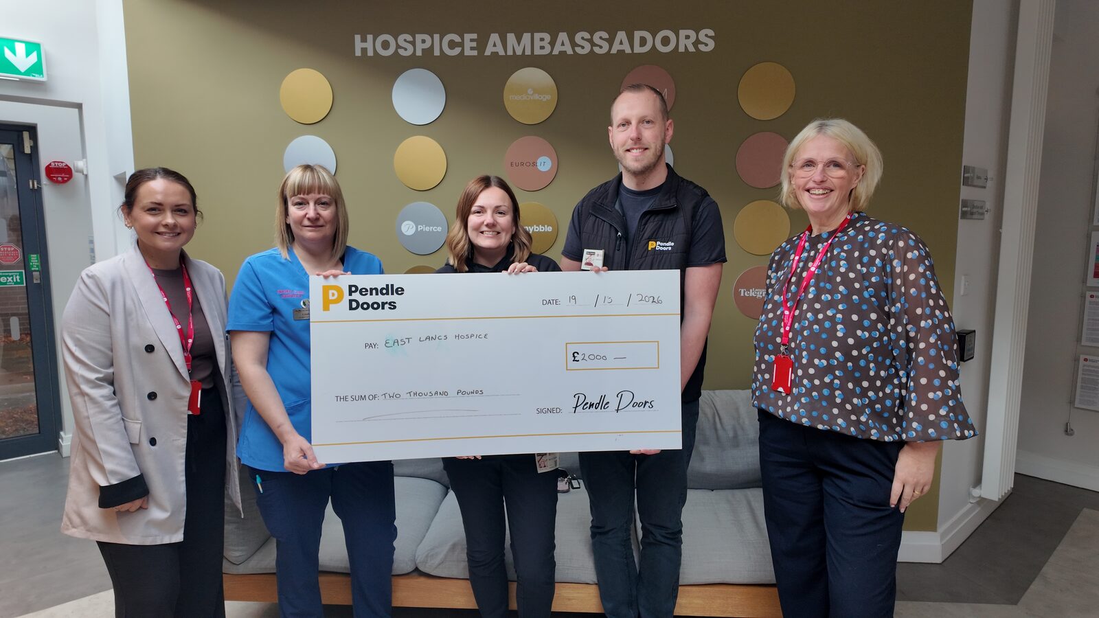 Pendle Doors Wellbeing Team presenting a £2,000 cheque to East Lancashire Hospice